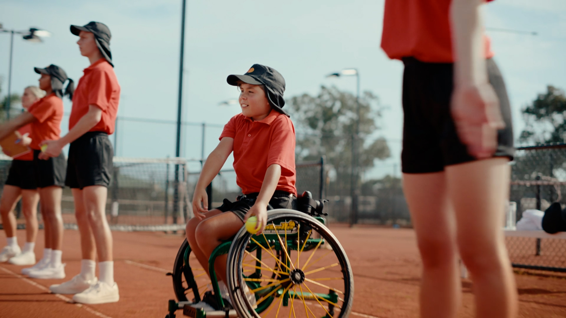 Man and woman walking on tennis court with Mastercard branding